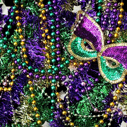 The image features colorful beads and a decorative mask in shades of purple, green, and gold, likely associated with a festive or carnival event.