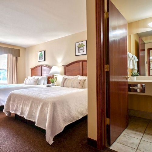 Room types include double queen, two-room suites, king suites, and whirlpool suites, each with its own kitchenette.