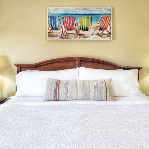 Room types include double queen, two-room suites, king suites, and whirlpool suites, each with its own kitchenette.